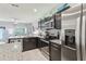 Well-equipped kitchen featuring granite counters, stainless steel appliances, and dark cabinets, open to the living room at 3158 Victoria Inlet Dr, Holiday, FL 34691