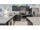 Galley kitchen with dark wood cabinets, granite countertops, and stainless steel appliances at 3158 Victoria Inlet Dr, Holiday, FL 34691