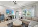 Living room with large sectional, decorative fireplace, ceiling fan, and natural light at 3158 Victoria Inlet Dr, Holiday, FL 34691