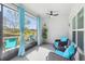 Bright sunroom with outdoor views, modern furniture, a ceiling fan, and neutral flooring at 3158 Victoria Inlet Dr, Holiday, FL 34691