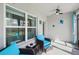 Enclosed sunroom with bright modern furniture, neutral flooring, and beautiful outdoor views at 3158 Victoria Inlet Dr, Holiday, FL 34691