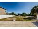 Spacious backyard featuring a white fence and mature trees, offering privacy and shade at 3216 W Paxton Ave, Tampa, FL 33611