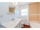 Bathroom featuring a toilet, tub, and sink with large mirror at 3216 W Paxton Ave, Tampa, FL 33611