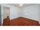 Modest bedroom with two doorways, one window, and a ceiling fan at 3216 W Paxton Ave, Tampa, FL 33611
