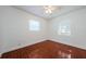 Clean bedroom showcasing tile floors, white walls, and natural light from two windows at 3216 W Paxton Ave, Tampa, FL 33611
