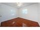 A simple bedroom with two windows, tile floors, and bright lighting at 3216 W Paxton Ave, Tampa, FL 33611