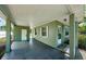 View of covered carport area with exterior door and windows, providing extra covered space at 3216 W Paxton Ave, Tampa, FL 33611