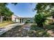 Inviting single-story home with covered carport and a well-maintained front lawn with mature shrubbery at 3216 W Paxton Ave, Tampa, FL 33611