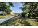 Charming single-story home with a covered carport and mature trees in the front yard at 3216 W Paxton Ave, Tampa, FL 33611