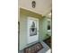 Close-up of front door features white frame, patterned glass window, and small welcome mat at 3216 W Paxton Ave, Tampa, FL 33611