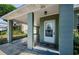 Welcoming entryway with a covered porch and decorative glass front door, ensuring easy access at 3216 W Paxton Ave, Tampa, FL 33611