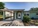 Close-up of the home's front entrance, featuring a covered carport and classic white door at 3216 W Paxton Ave, Tampa, FL 33611