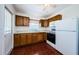 Functional kitchen includes appliances, wooden cabinetry, and adjacent counter space at 3216 W Paxton Ave, Tampa, FL 33611