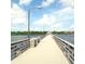 Scenic pier view with wooden railings, blue sky, and distant trees at 3216 W Paxton Ave, Tampa, FL 33611