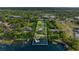 Breathtaking aerial view of a lakeside home with private dock and lush landscaping at 3407 W Busch Blvd, Tampa, FL 33618