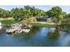 Stunning aerial view of lakefront home with private boat dock and lush landscaping on a sunny day at 3407 W Busch Blvd, Tampa, FL 33618