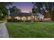 Expansive backyard with a screened-in patio and lush green lawn, ideal for outdoor enjoyment at 3407 W Busch Blvd, Tampa, FL 33618