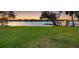 Expansive lawn leading to a private boat dock with scenic lake views at dusk at 3407 W Busch Blvd, Tampa, FL 33618