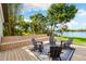 Relax on this backyard deck with scenic lake views and tiered bench seating, perfect for entertaining at 3407 W Busch Blvd, Tampa, FL 33618