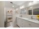 Elegant bathroom with double marble vanity, framed mirror, glass shower and crystal chandelier at 3407 W Busch Blvd, Tampa, FL 33618