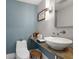 Chic half bath with a vessel sink, modern lighting, and a decorative accent wall at 3407 W Busch Blvd, Tampa, FL 33618