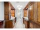 Bathroom showcasing dual sinks with wood cabinetry and granite countertops, complemented by tile flooring at 3407 W Busch Blvd, Tampa, FL 33618
