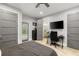 Bedroom features gray walls, ceiling fan, and multiple doors to the exterior and ensuite bathroom at 3407 W Busch Blvd, Tampa, FL 33618