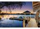 Charming boat dock with watercraft, providing easy access to the serene lake and breathtaking sunset views at 3407 W Busch Blvd, Tampa, FL 33618