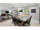 Elegant dining room with a rustic wood table, fireplace, and plantation shutters at 3407 W Busch Blvd, Tampa, FL 33618