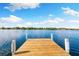 A wooden dock extends over the tranquil waters, providing a serene escape with stunning views at 3407 W Busch Blvd, Tampa, FL 33618