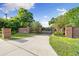 Grand gated entrance with brick pillars and manicured landscaping, providing privacy at 3407 W Busch Blvd, Tampa, FL 33618