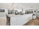 Spacious open kitchen with white cabinetry, breakfast bar, and seamless flow to adjacent living spaces at 3407 W Busch Blvd, Tampa, FL 33618