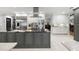 Modern kitchen with gray island, stainless steel appliances, and open layout for entertaining at 3407 W Busch Blvd, Tampa, FL 33618
