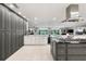 Open kitchen boasts custom cabinetry, stainless appliances, and access to outdoor pool area at 3407 W Busch Blvd, Tampa, FL 33618