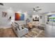 Bright living room with neutral tones, modern decor, and seamless access to outdoor spaces at 3407 W Busch Blvd, Tampa, FL 33618