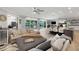 Open concept living area with pool view through large sliding doors, fireplace, and kitchen at 3407 W Busch Blvd, Tampa, FL 33618