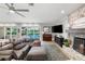 Inviting living area with stone fireplace, pool view, and transitional design elements at 3407 W Busch Blvd, Tampa, FL 33618