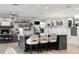 Spacious kitchen with island seating and an adjacent living area with a stone fireplace at 3407 W Busch Blvd, Tampa, FL 33618