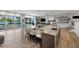 Kitchen with a large island with seating and views of the pool and lake at 3407 W Busch Blvd, Tampa, FL 33618