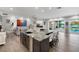 The kitchen island with a sink overlooks the living room, pool, and lake views at 3407 W Busch Blvd, Tampa, FL 33618