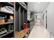 Well-organized mudroom with built-in storage, granite bench, and a view to the kitchen at 3407 W Busch Blvd, Tampa, FL 33618