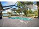 A screened pool offers a serene waterfront view and ample space for entertaining at 3407 W Busch Blvd, Tampa, FL 33618