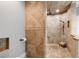 Step into luxury with this walk-in shower, adorned with elegant tile work, a rainfall shower head, and built-in niche at 3407 W Busch Blvd, Tampa, FL 33618