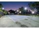Outdoor tennis court lit for evening play, perfect for enjoying a match with friends and Gathering at 3407 W Busch Blvd, Tampa, FL 33618