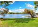 An expansive lawn gently slopes to meet the tranquil waterfront, providing scenic views at 3407 W Busch Blvd, Tampa, FL 33618