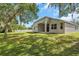 Backyard featuring green lawn, privacy fence, and covered patio with exterior views at 3527 101St E Ave, Parrish, FL 34219