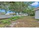 The large backyard boasts mature trees and a white vinyl fence, creating a private oasis at 3527 101St E Ave, Parrish, FL 34219