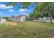 A large backyard provides green space and privacy, with a vinyl fence and mature trees at 3527 101St E Ave, Parrish, FL 34219