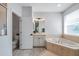 Large bathroom with separate shower, tub, and vanity with white cabinets at 3527 101St E Ave, Parrish, FL 34219