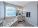 This bathroom features a garden tub, window, and ample lighting at 3527 101St E Ave, Parrish, FL 34219